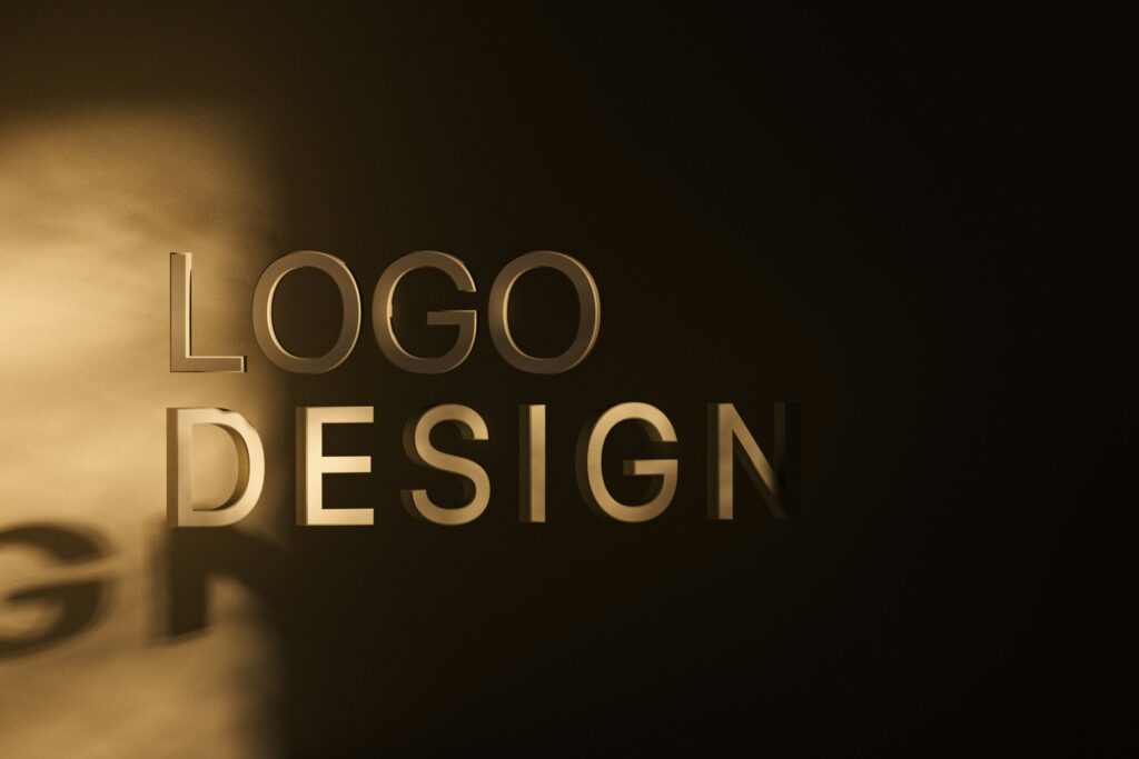 3D metallic text displaying the words “Logo Design” on a dark background.